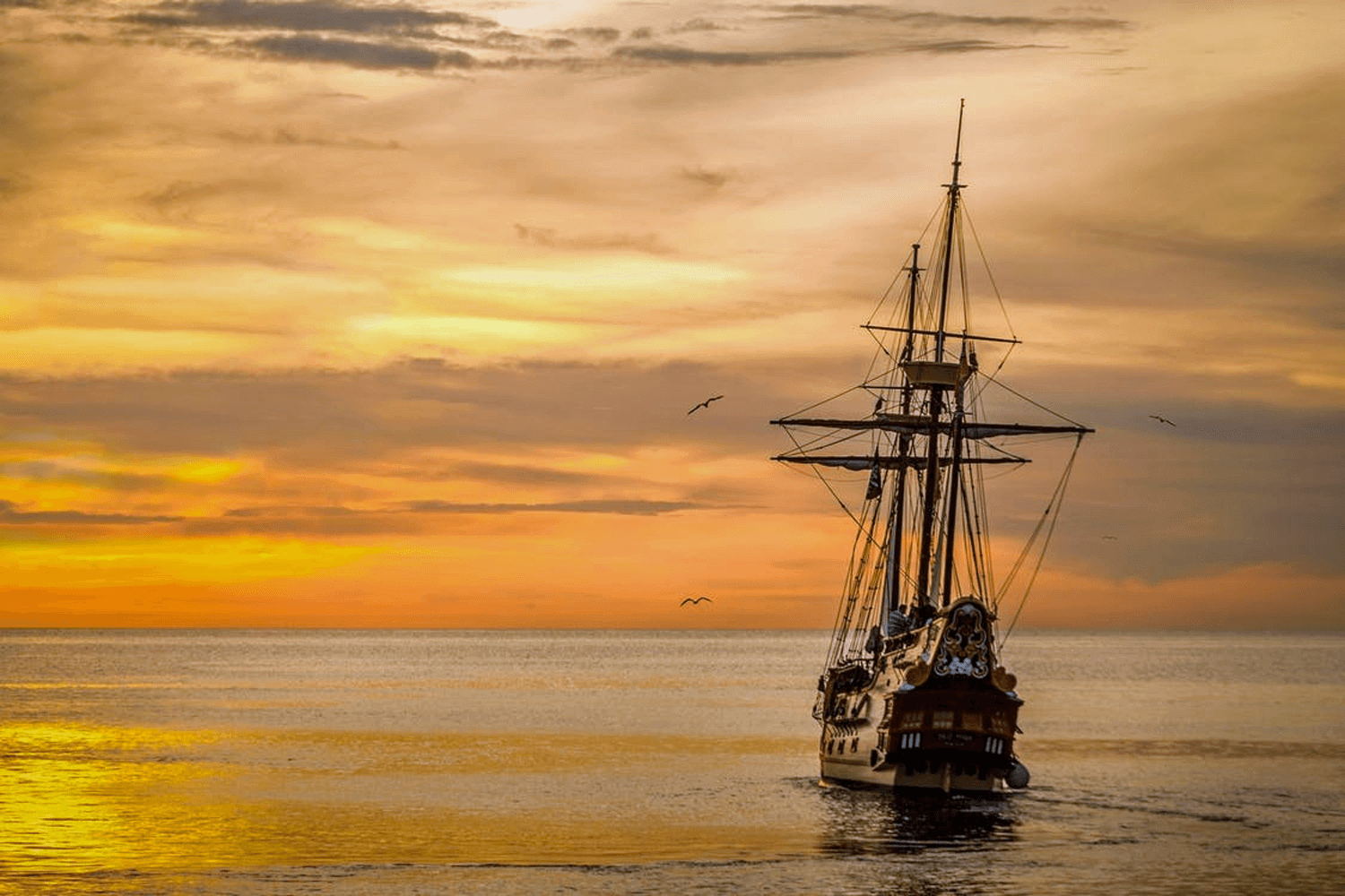 Pirate ship sailing in sunset