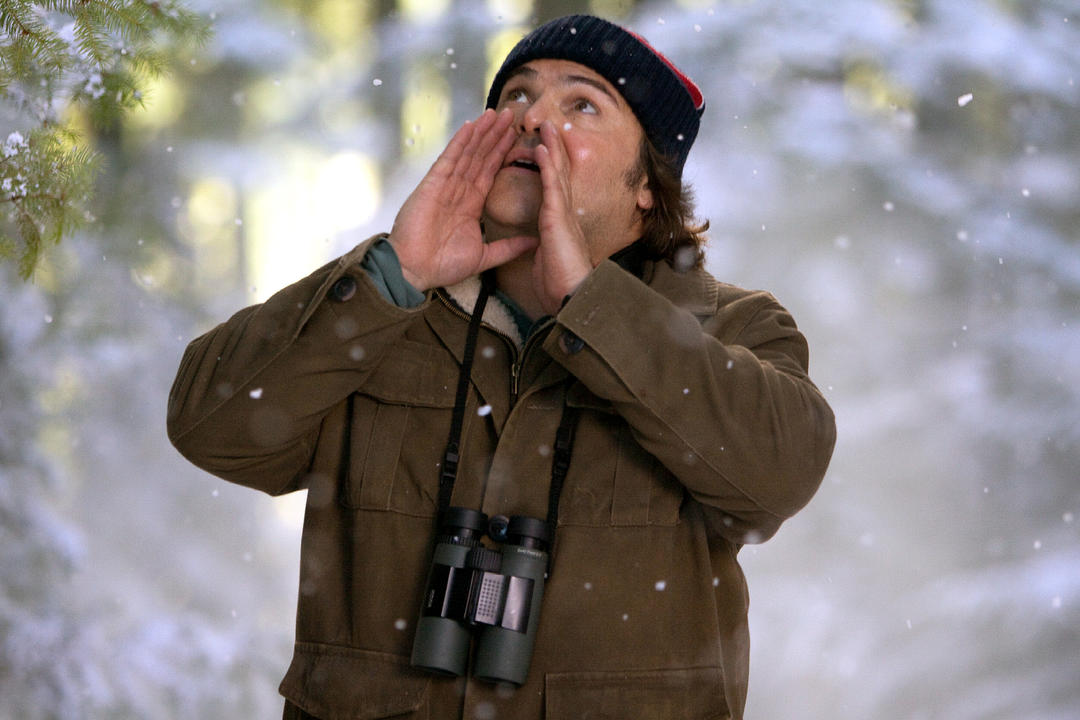 Jack Black calling birds in the snow in the Big Year film